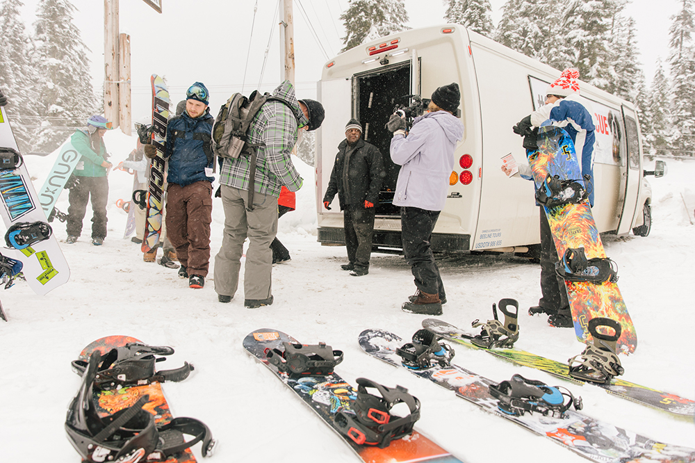 Snowboarders getting their gear out of motorcoach